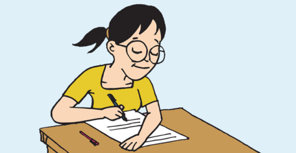 girl in a yellow shirt writing and sitting at a desk